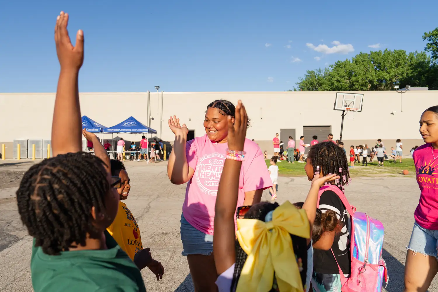 Children raising hands during a group activity