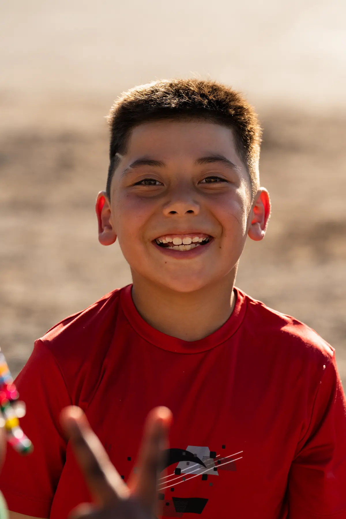 Child in red shirt smiling